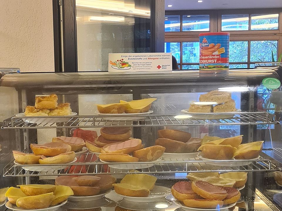 Abgebildet ist die Kühlvitrine, an der die Verpflegung, belegte Brötchen, Brötchen mit Würstchen und Kuchen ausgegeben werden.